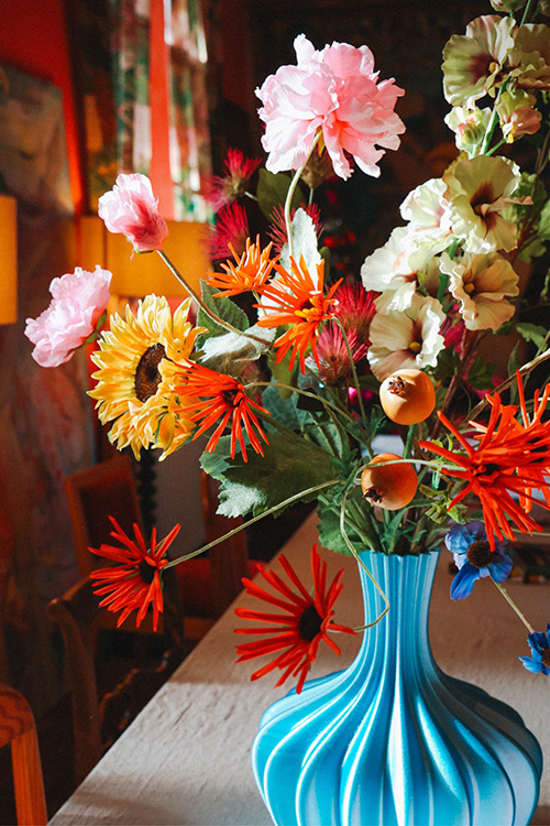 Colorful flower bouquet in turquoise vase