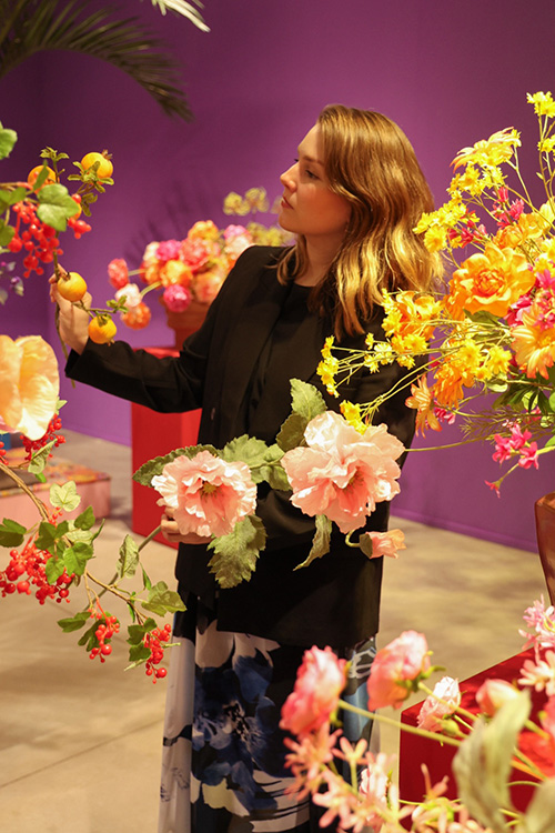 Marylène Madou arranging flowers purple background