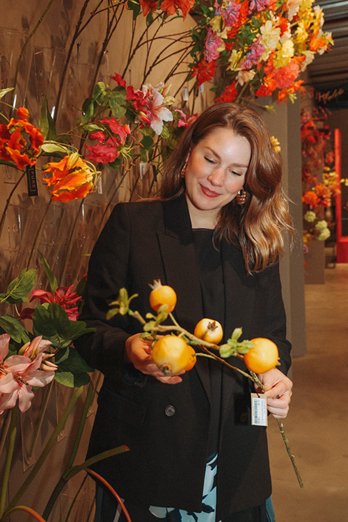 Marylène Madou selecting artificial flowers in shop
